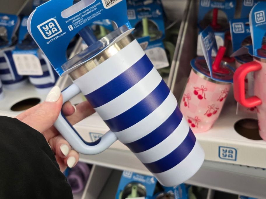 hand holding yaya tumbler with stripes on it in store