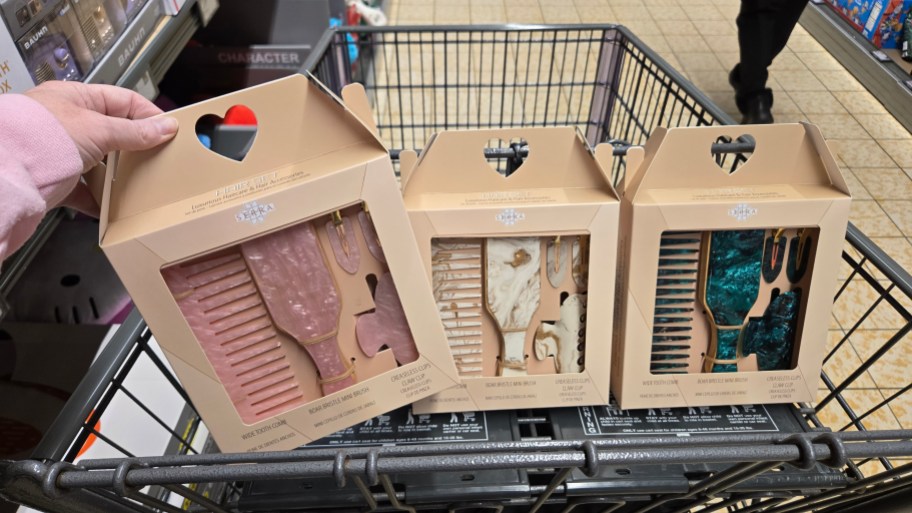 hand holding pink hair brush