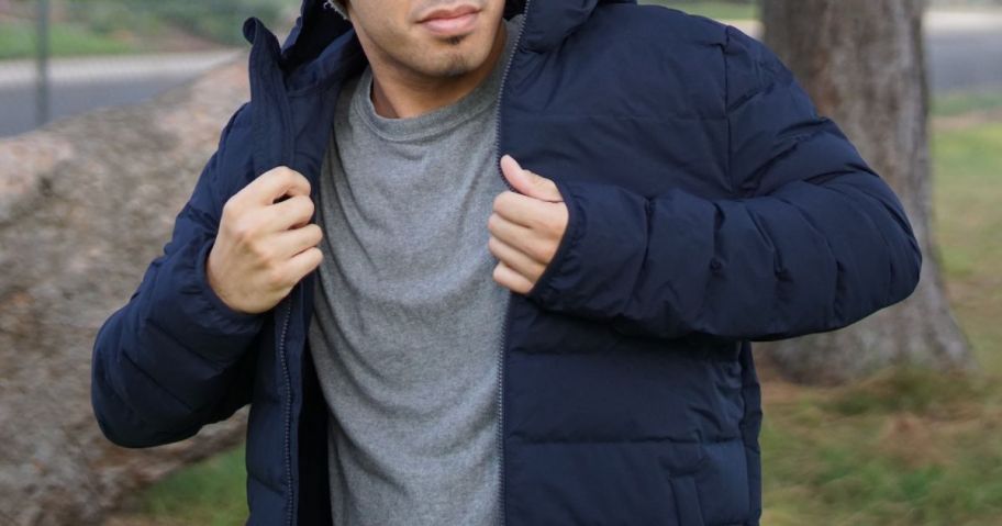 Man putting on a 32 Degrees puffer jacket