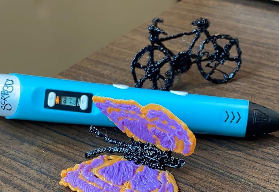 blue 3d pen on table with butterfly and bike
