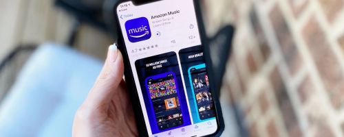 Hand holding a phone with Amazon music unlimited