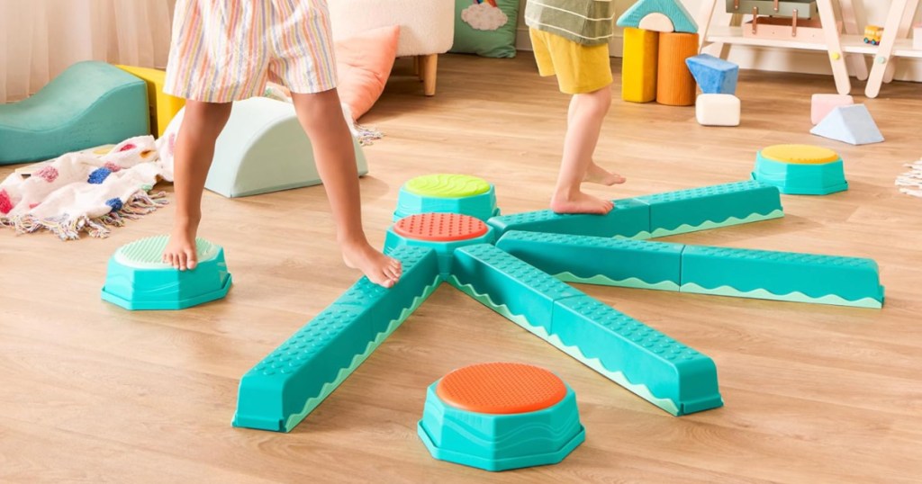 Little boy and girl bouncing on blue sensory balance beams set