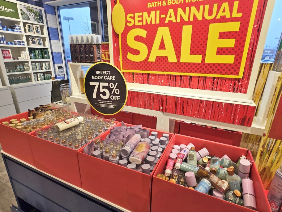 Bath & Body Works body care items with semi-annual sale signs