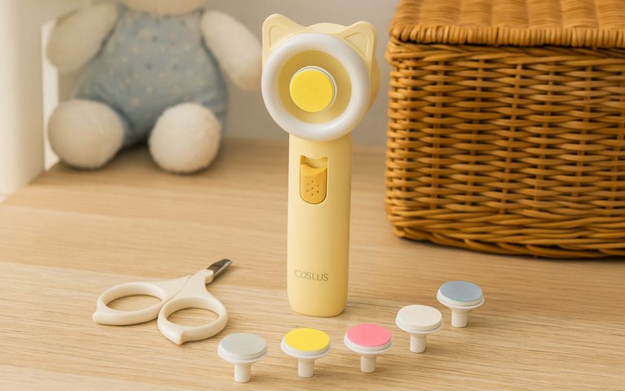 image of COSLUS Electric Baby Nail Trimmer with items displayed on top of the table 