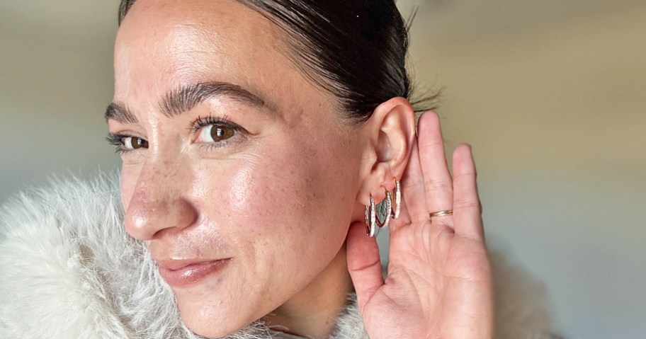 woman wearing 3 hoop earrings