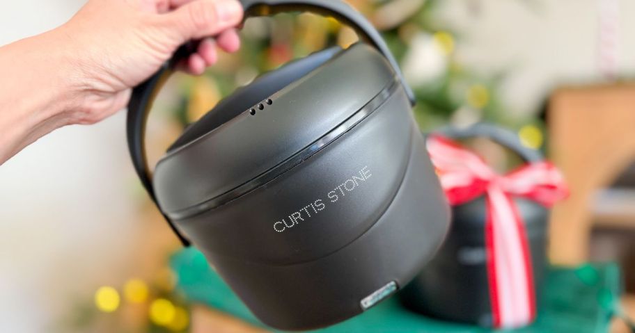 hand holding a Curtis Stone portable food warmer