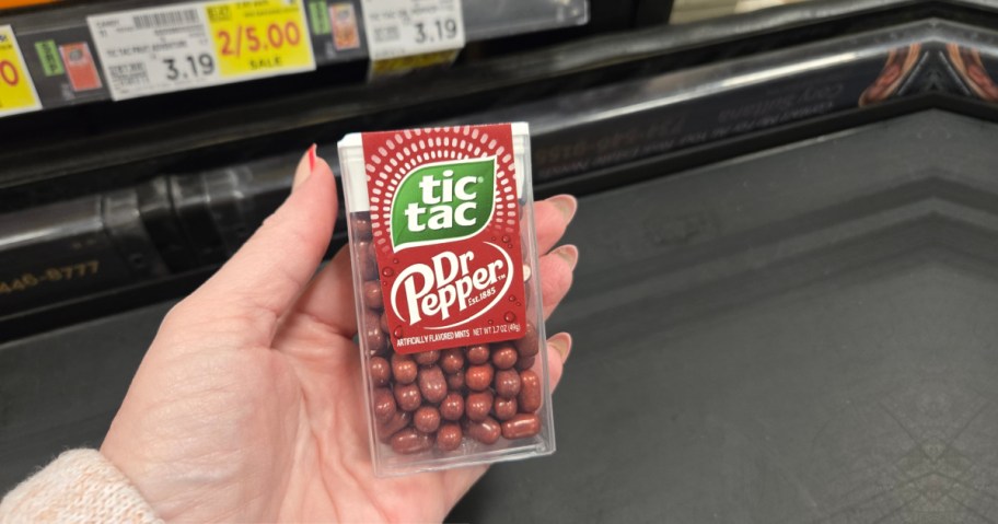 Hand holding up Dr Pepper Tic Tacs inside Kroger store