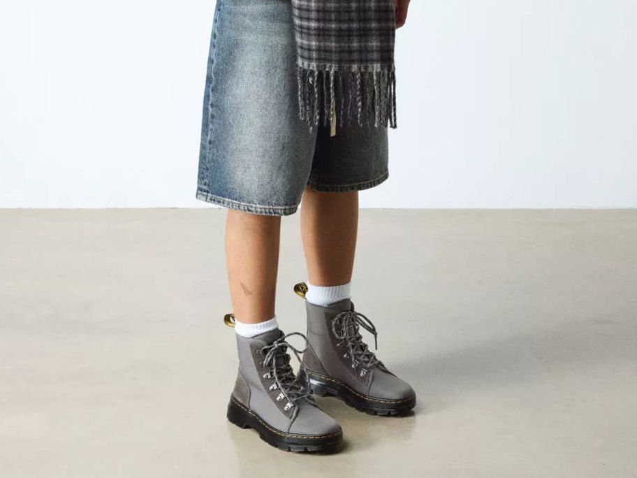 Woman's legs and feet wearing Gray Dr. Martens Combs Utility Boots