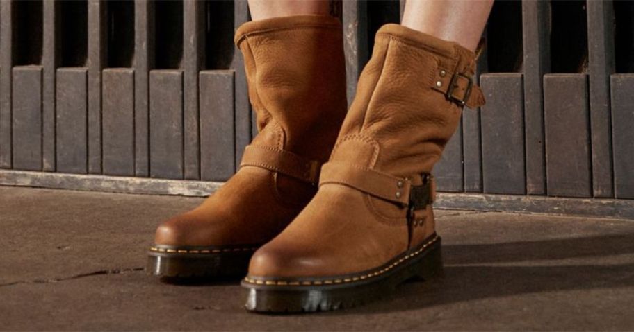 A person wearing brown leather boots