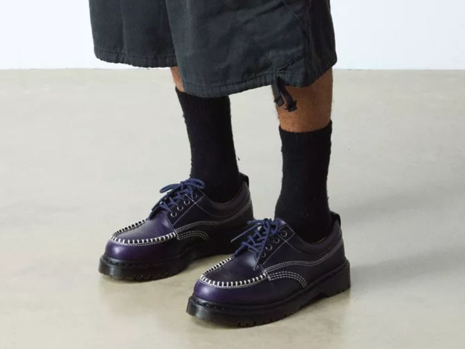 A person wearing midnight blue shoes