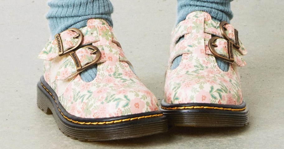 girl wearing floral print mary jane shoes