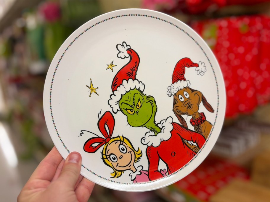 hand holding up Dr. Seuss Grinch, Max, & Cindy Lou Who Plate