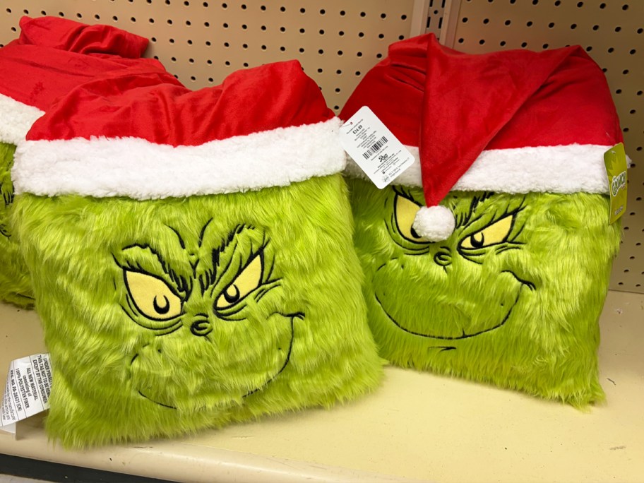 The Grinch wearing Santa hat throw pillows