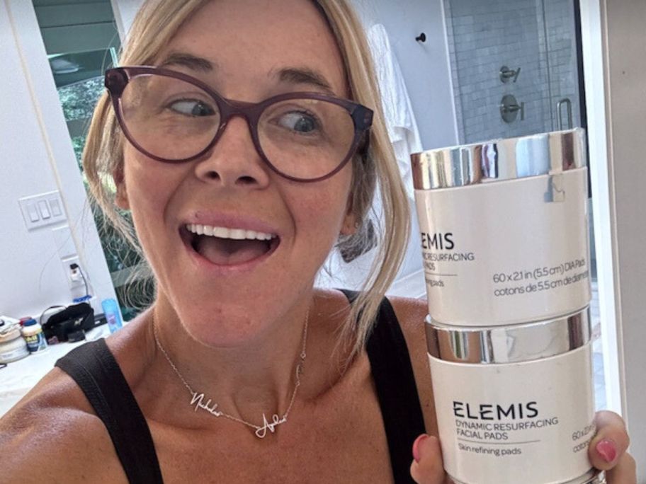Woman holding two jars of Elemis Resurfacing Pads