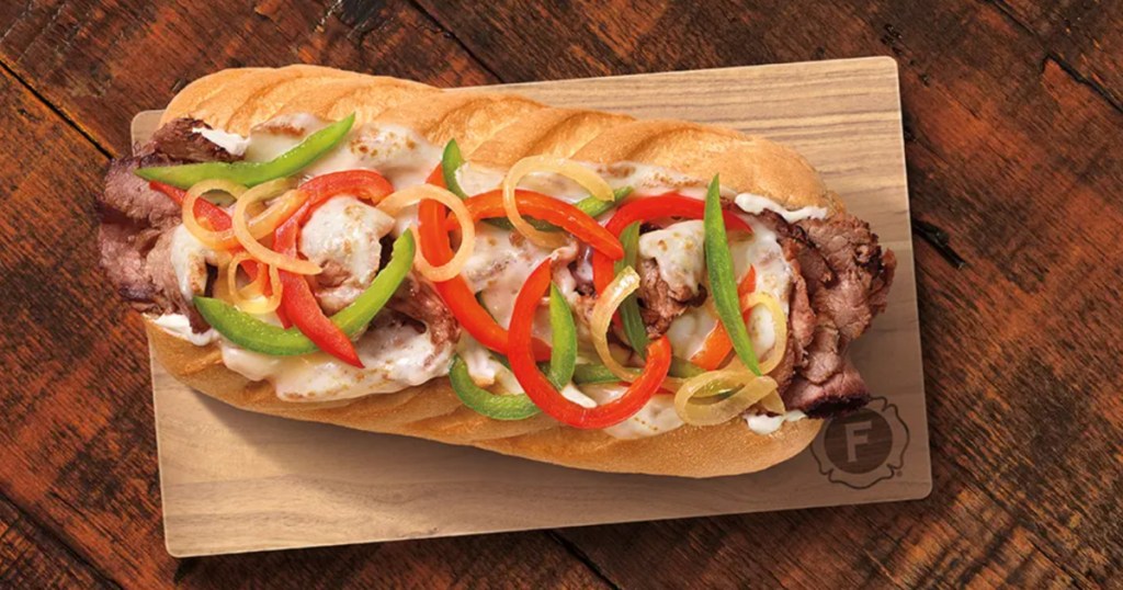 Firehouse Steak & Cheese Melt sandwich on wooden cutting board