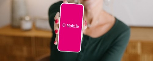 woman holding a phone with T-Mobile on it