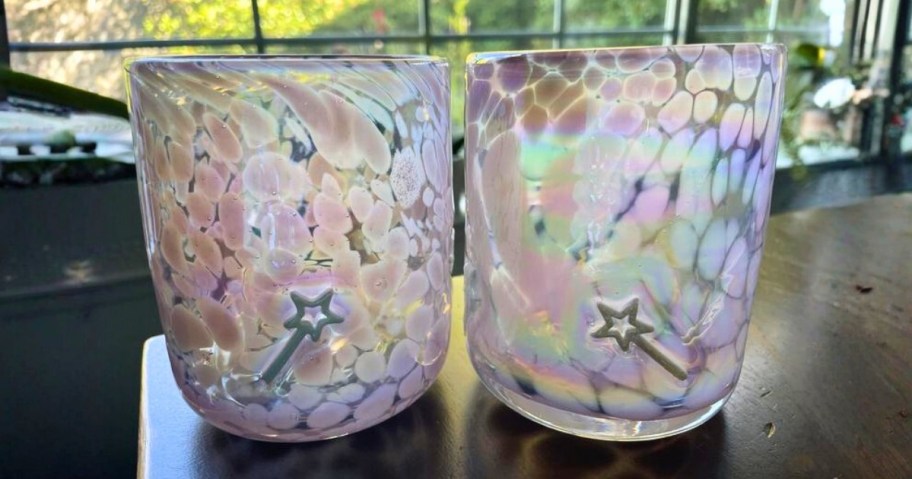 two Antrhopologie Icon Juice glasses in pink with a wand icon