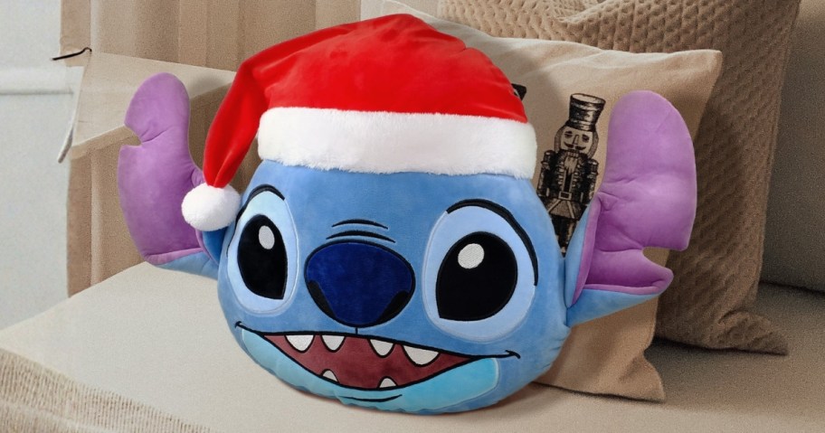 Disney Stitch in a Santa hat throw pillow on a couch