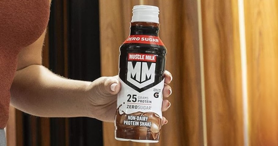 hand holding a Muscle Milk shake bottle