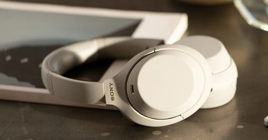 a pair of silver Sony headphones on a desk