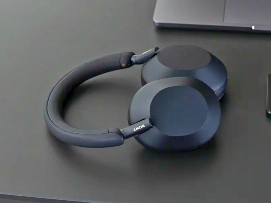 a black pair of Sony headphones on a desk