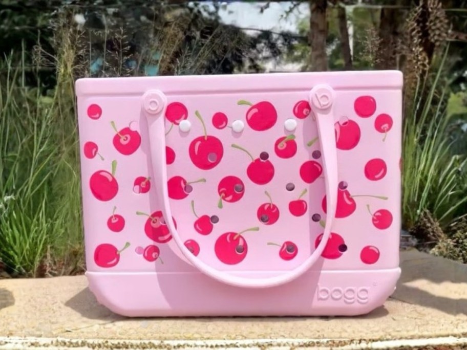 a pink Bogg Bag with a cherry print