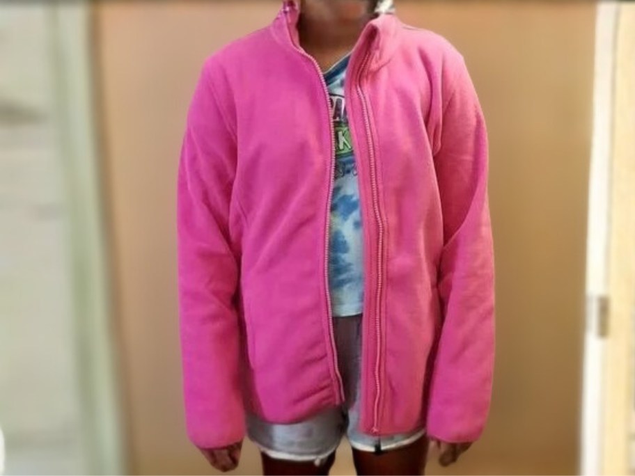 girl wearing a hot pink zip up fleece jacket