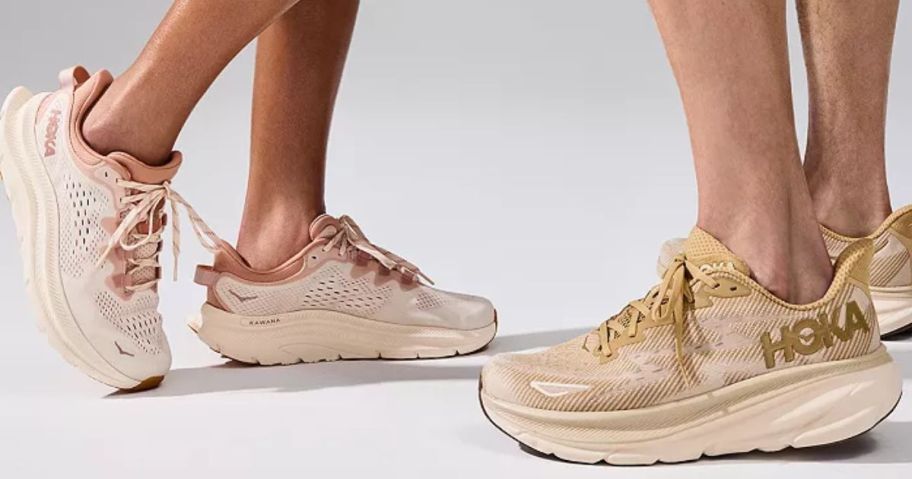 Man and woman wearing HOKA running shoes