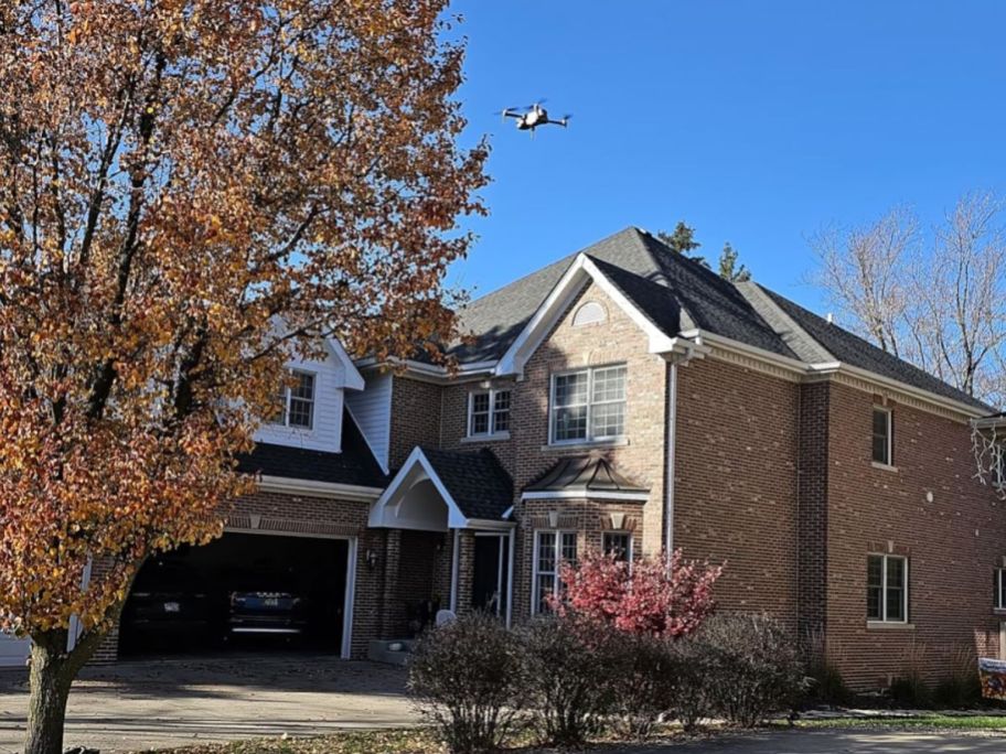 A Hocany drone flying over a house
