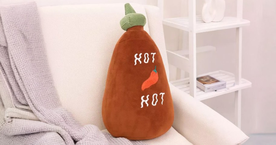Hot Ssuce Weighted Pillow sitting on a chair