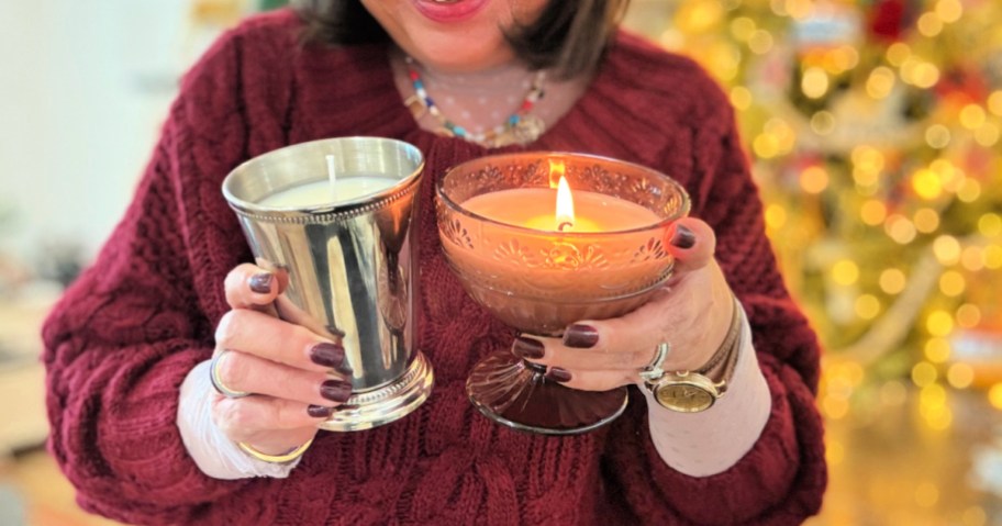 holding homemade candles from thrift finds