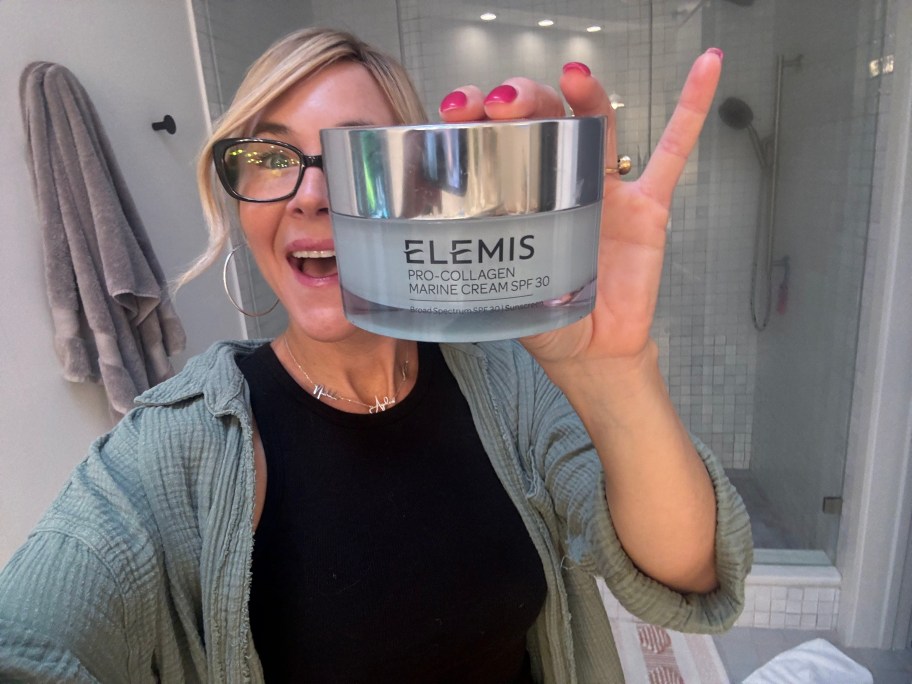 Woman holding Elemis product