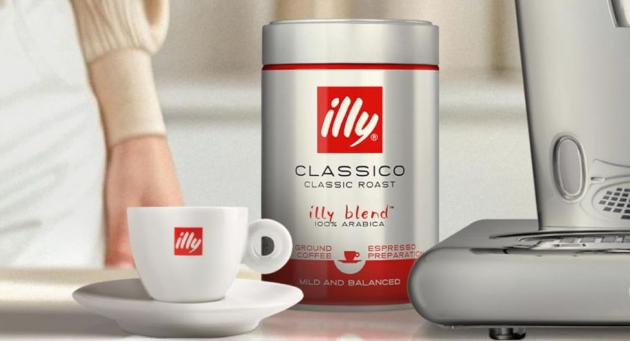 cup of coffee next to ground coffee set