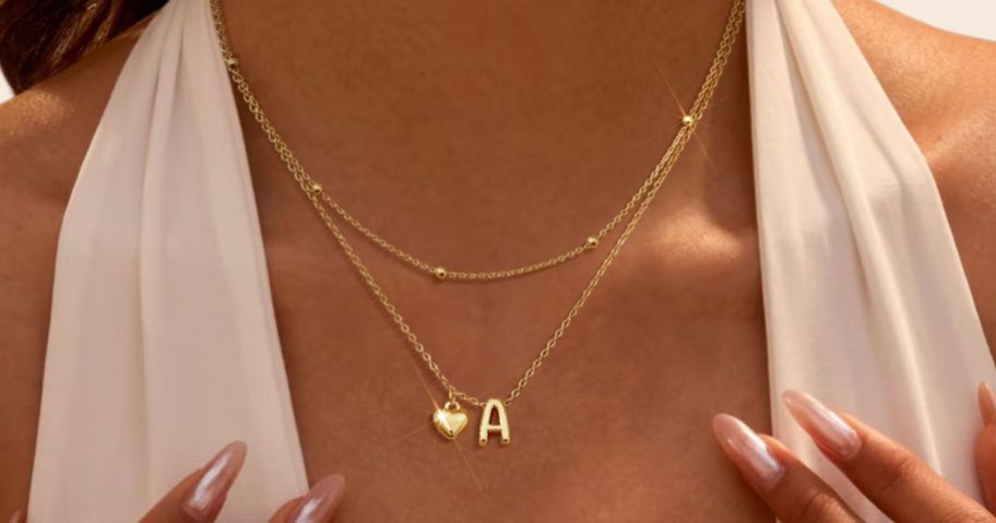 womans neck with a Stacked Initial Heart Necklace