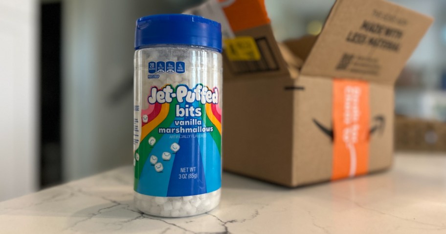 Jet puff marshmallow bits in container on countertop in front of Amazon box