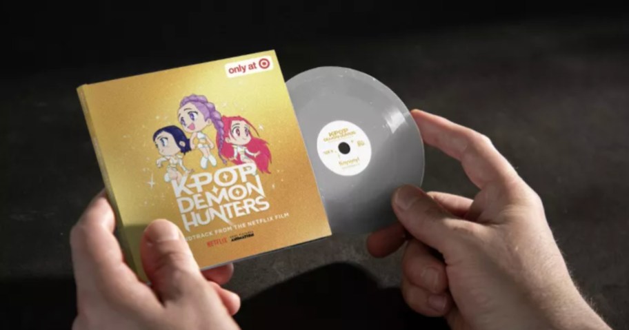 Person holding tiny record featuring K-pop Demon hunters music
