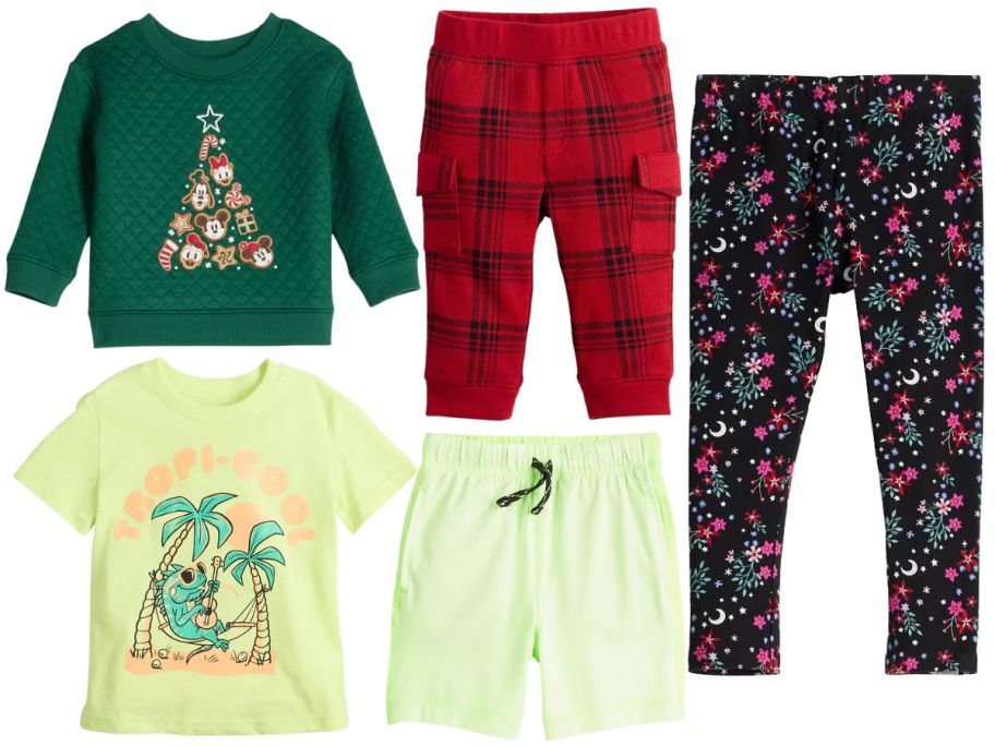 Several kids clothing items: sweatshirts, 2 pairs of long pants, a short-sleeved shirt and a pair of shorts