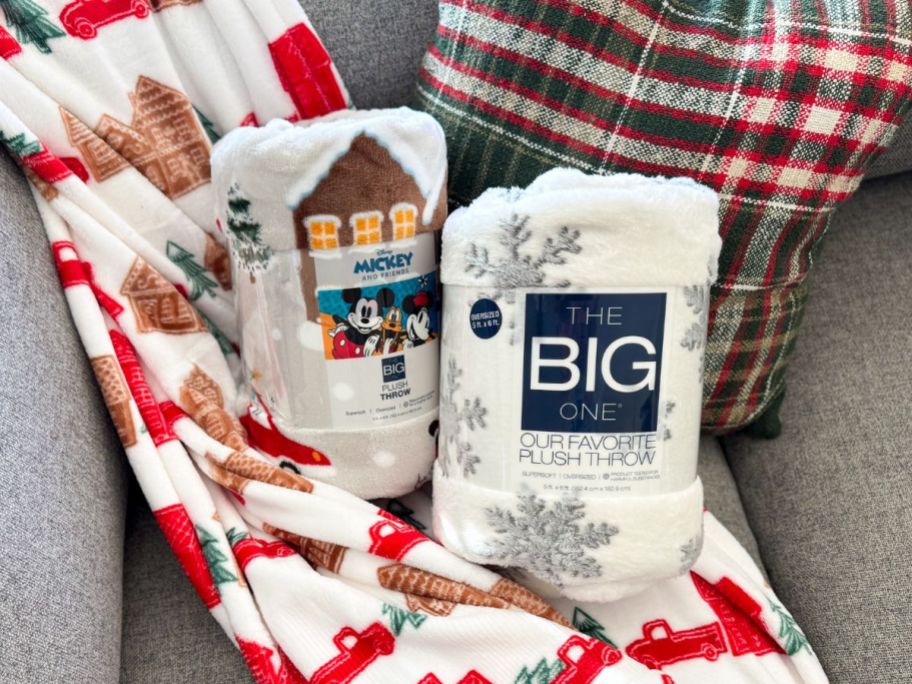 A couch with 3 Kohl's The Big One Holiday Throws on It