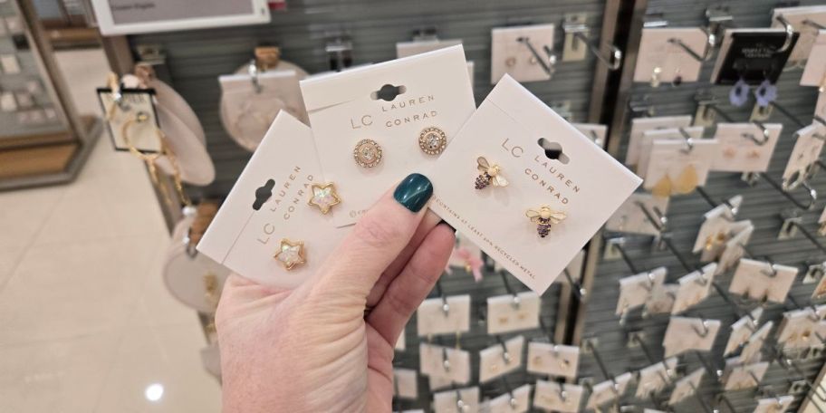 A person holding earrings