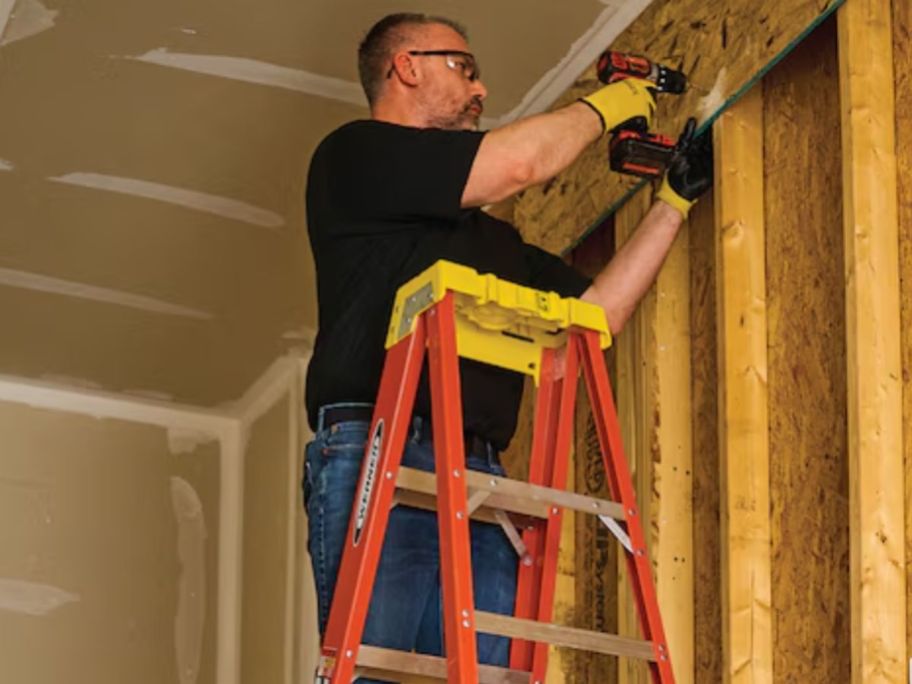 man standing on a Werner Extendable 6' Fiberglass Step Ladder