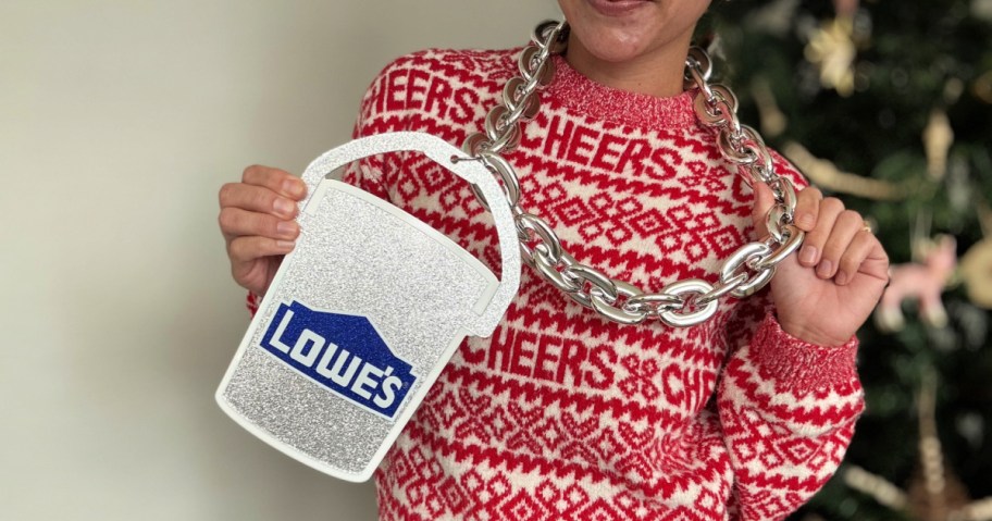 Woman in holiday sweater wearing giant Lowe's silver chain necklace
