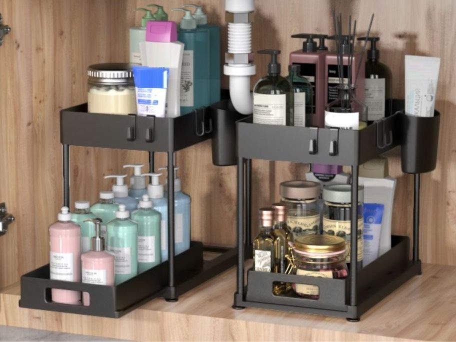 2 black Under sink organizers filled with products