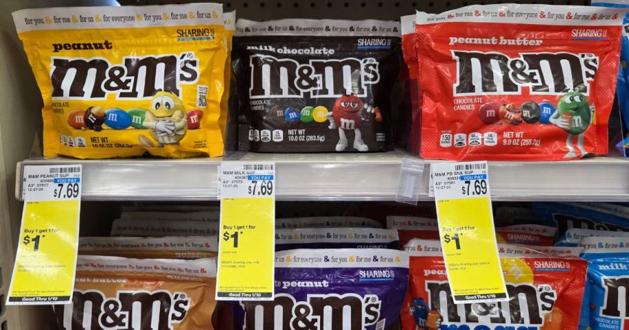 Several large M&M bags on a shelf in a store