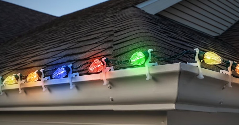 a strand of led lights attached to the gutter of a home