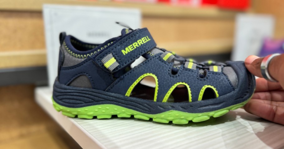Blue and green merrell, water shoes on display in store