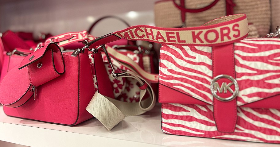 pink Michael Kors bags on store shelf