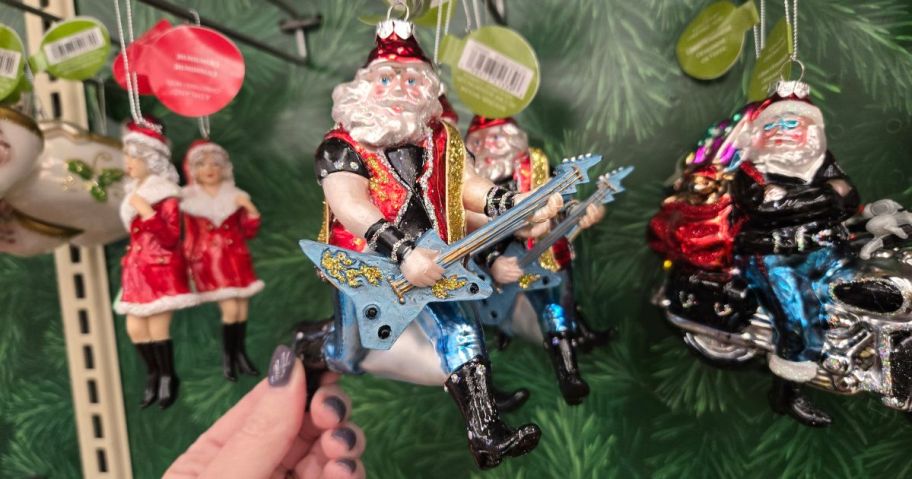 A glass Santa with a guitar ornament in a store