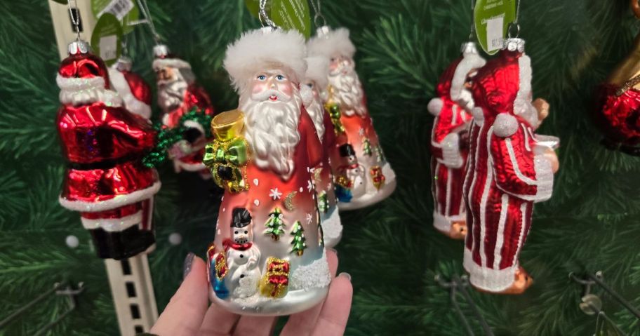 A glass Santa ornament in a store