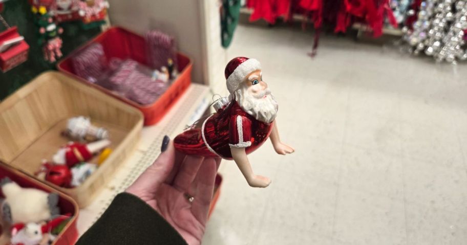 A glass Santa ornament in a store