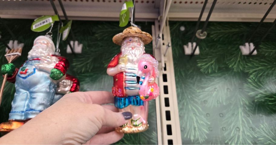A glass Santa ornament in a store